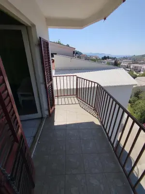 a balcony of a house with an open door at Aprtman 2 in Sutomore