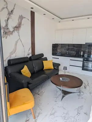 a living room with a black couch and a table at Apartment Anja in Dobra Voda