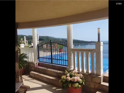 a balcony with stairs and a view of the water at Apartment Anja in Dobra Voda