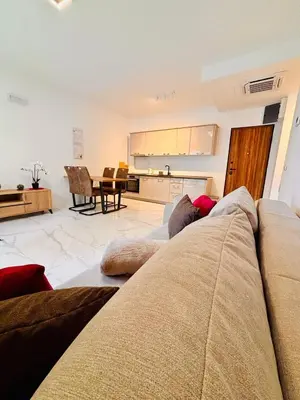 a living room with a couch and a kitchen at Monte Rama Suite Rafailovici in Budva