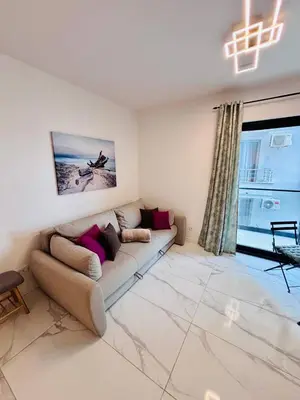 a living room with a couch and a window at Monte Rama Suite Rafailovici in Budva