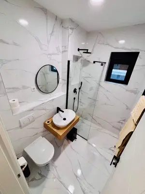 a bathroom with a sink and a toilet and a mirror at Monte Rama Suite Rafailovici in Budva