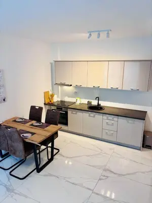 a kitchen with a table and chairs in a room at Monte Rama Suite Rafailovici in Budva