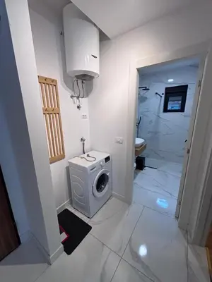 a bathroom with a washing machine and a shower at Monte Rama Suite Rafailovici in Budva
