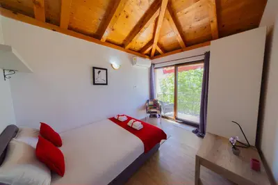 a bedroom with a bed with red pillows at Villa Rustique in Budva