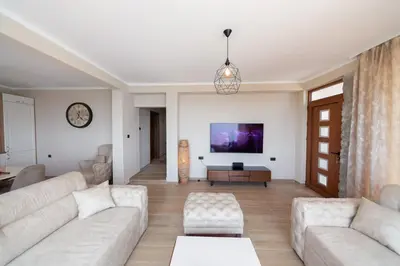 a living room with a couch and a tv at Villa Jana Lapčići in Lapčići