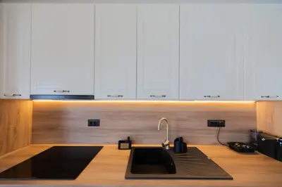 a kitchen with a sink and white cabinets at Villa Jana Lapčići in Lapčići