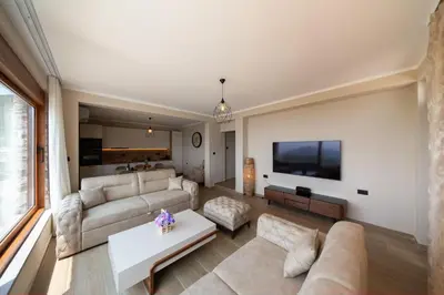 a living room with a couch and a tv at Villa Jana Lapčići in Lapčići