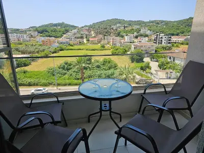 a table and chairs on a balcony with a view at Moon Apartment in Ulcinj