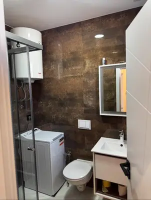 a bathroom with a toilet and a sink at Moon Apartment in Ulcinj