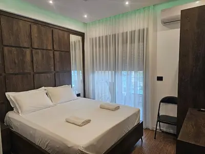 a bedroom with a large bed and a window at Moon Apartment in Ulcinj