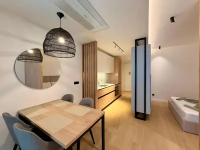 a kitchen and dining room with a table and chairs at Onia Luxury Escape in Budva