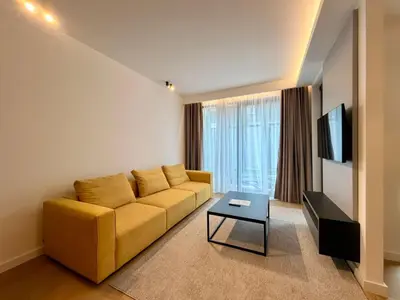 a living room with a yellow couch and a tv at Onia Luxury Escape in Budva