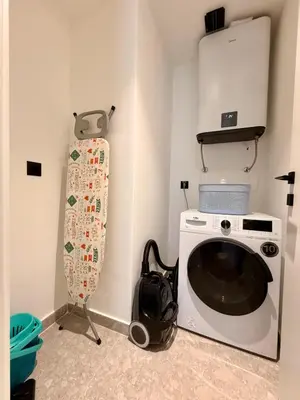 a washing machine in a room with a bag next to it at Onia Luxury Escape in Budva