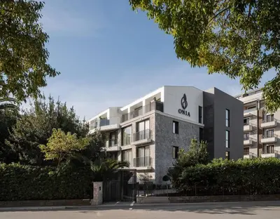 an apartment building with a sign on the front of it at Onia Luxury Escape in Budva