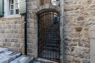 an entrance to a stone building with a black gate at Vila Lancana in Kotor