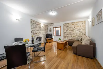 a living room with a couch and a table at Vila Lancana in Kotor