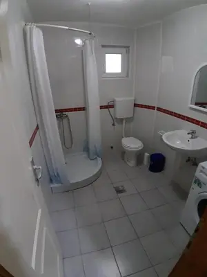 a bathroom with a shower and a toilet and a sink at Apartments Snezana in Bar