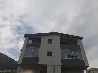 a tall apartment building with the sky in the background at Apartments Snezana in Bar