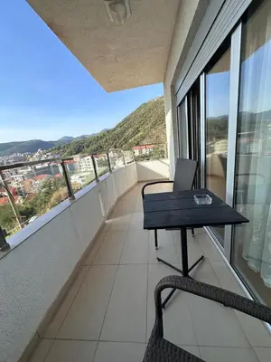 an office with a desk and chair on a balcony at Apartments EVG in Rafailovici