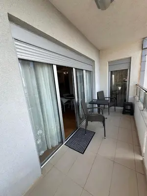 a room with a balcony with a sliding glass door at Apartments EVG in Rafailovici