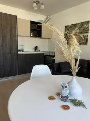 a white table with a vase on top of it at DimaX Apartments in Budva