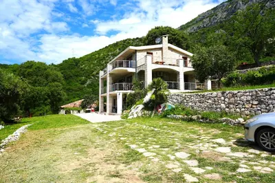 a house with a car parked in front of it at Eco Villa Buljarica in Buljarica