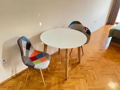 a white table and two chairs in a room at Eco Villa Buljarica in Buljarica