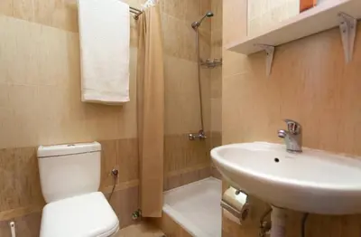 a bathroom with a toilet and a sink and a shower at Eco Villa Buljarica in Buljarica