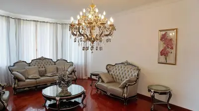 a living room with two couches and a chandelier at Villa Lux Radovici in Radovići