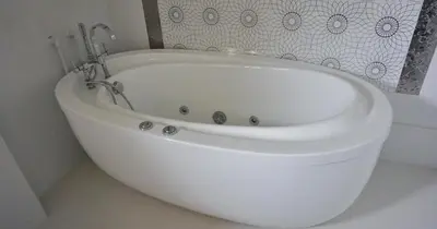 a white bath tub sitting in a bathroom at Villa Lux Radovici in Radovići