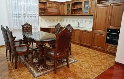 a kitchen with a dining room table and chairs at Villa Lux Radovici in Radovići