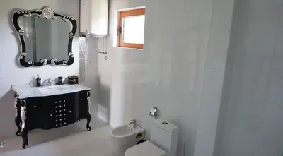 a bathroom with a sink and a toilet and a mirror at Villa Lux Radovici in Radovići