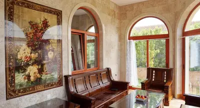a living room with a bench and a painting and windows at Villa Lux Radovici in Radovići