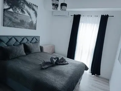 a bedroom with a bed with a hat on it at Cozy Home in Ulcinj