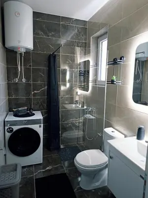 a bathroom with a toilet and a sink and a shower at Cozy Home in Ulcinj