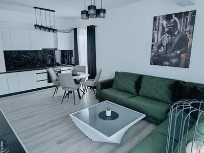 a living room with a green couch and a table at Cozy Home in Ulcinj