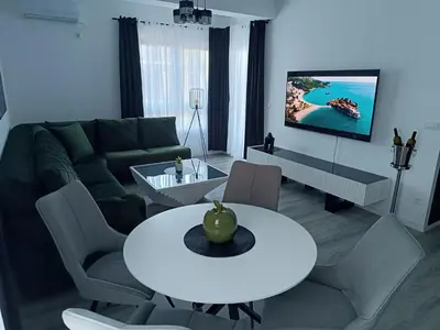 a living room with a white table and a couch at Cozy Home in Ulcinj