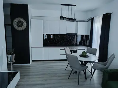 a kitchen and dining room with a table and chairs at Cozy Home in Ulcinj