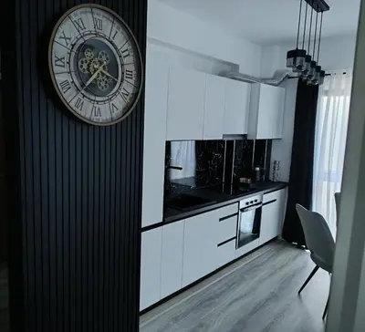 a kitchen with a large clock on the wall at Cozy Home in Ulcinj