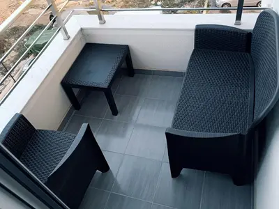 two chairs and a table on a balcony at Cozy Home in Ulcinj