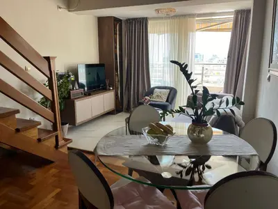 a living room with a glass table and chairs at sinbia apartment in Budva