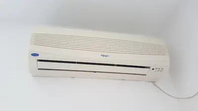 a white air conditioner sitting on a white background at Apartmani Famelja Jovanovic in Sveti Stefan