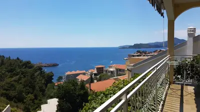 a balcony with a view of the ocean at Apartmani Famelja Jovanovic in Sveti Stefan