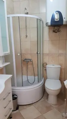 a bathroom with a shower and a toilet in it at Apartmani Famelja Jovanovic in Sveti Stefan