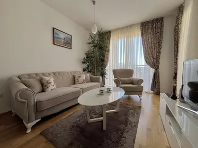 a living room with a couch and a table at Plaza Apartment in Budva