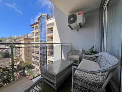 a balcony with chairs and a table on a balcony at Plaza Apartment in Budva