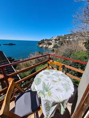 a table and chairs on a balcony overlooking the ocean at Family Sea View Ulcinj in Ulcinj