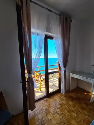 a room with a door with a view of the ocean at Family Sea View Ulcinj in Ulcinj
