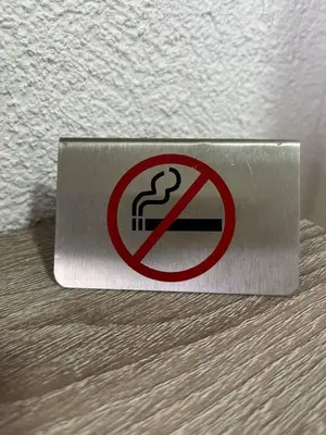 a no smoking sign on the corner of a wall at Lutovac Apartmani in Kotor